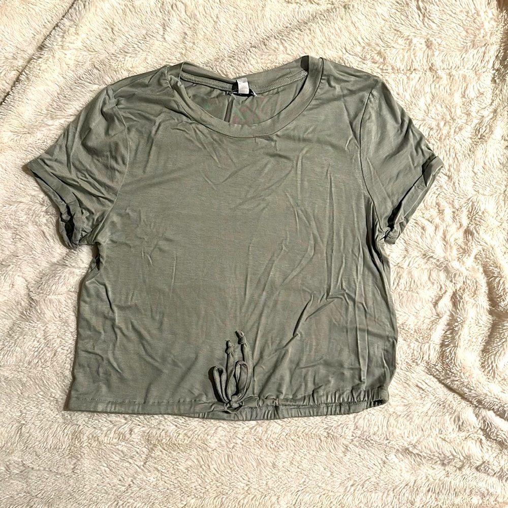A small, chute green loose crop top from “love, fire”